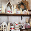Flocked Ivory Bottle Brush Trees on display on shelves